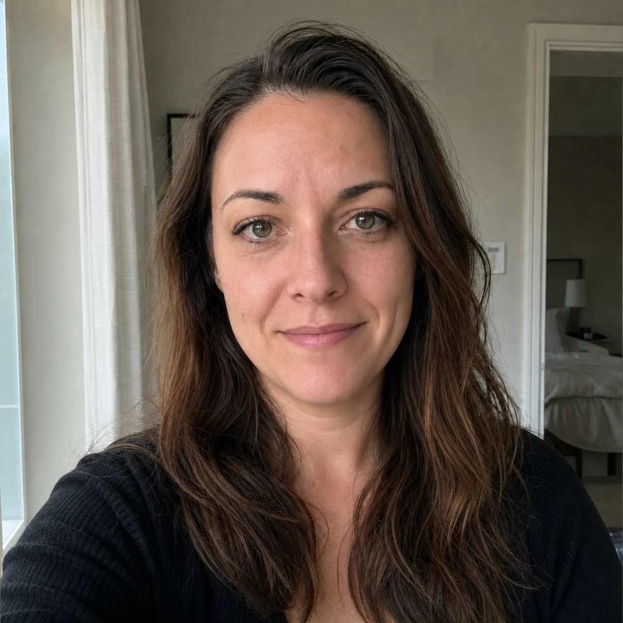 After edit: the indoor portrait with a subtle closed-mouth smile