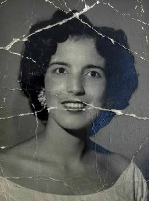 Before edit: a damaged portrait photograph with cracks and folds